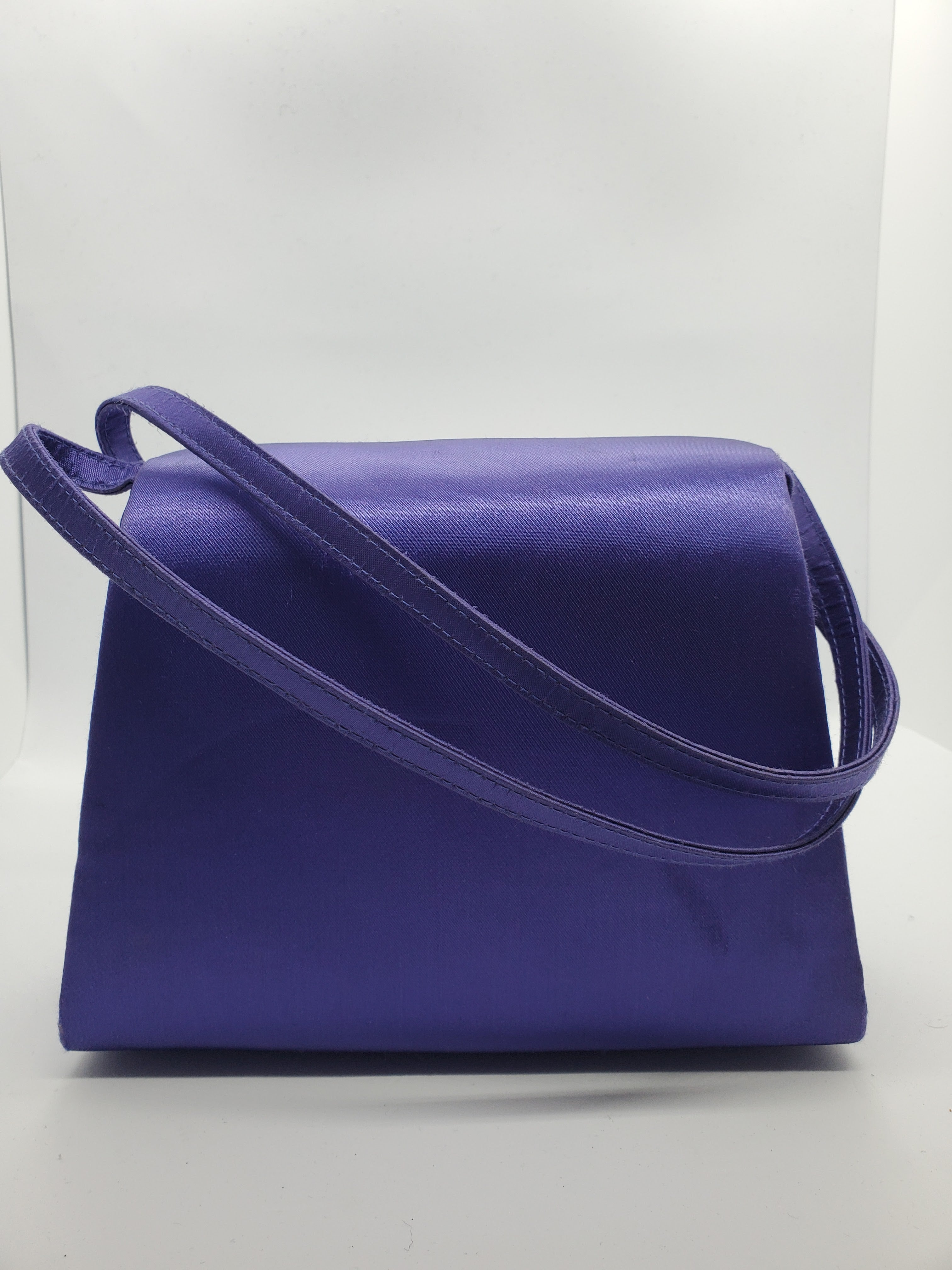 back view of purple handbag with woven details