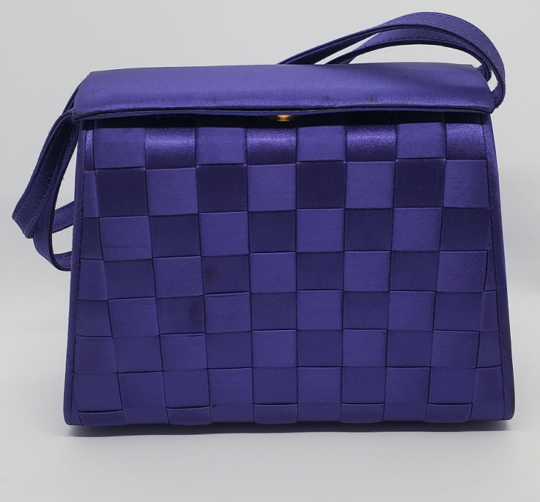 front view of purple handbag with woven details