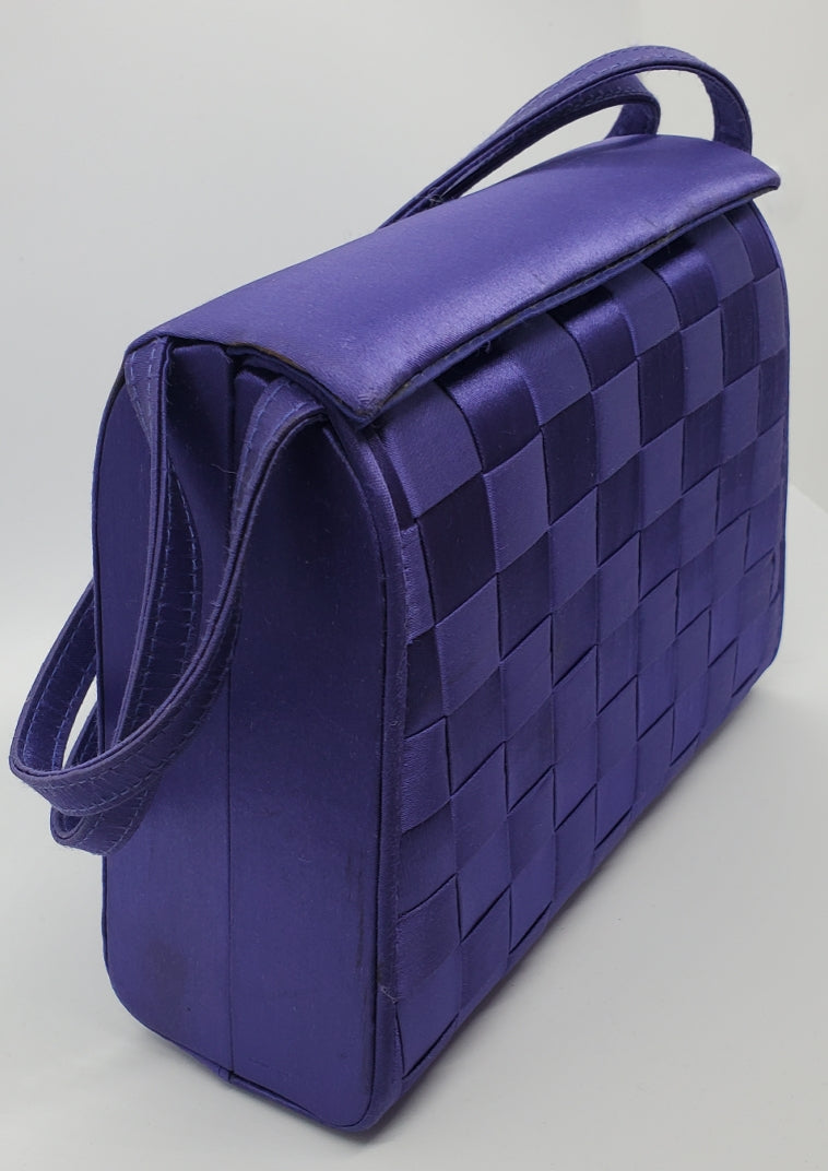 side view of purple handbag with woven details