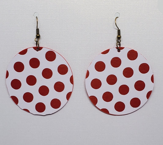 Red and white polka dot earrings on stand