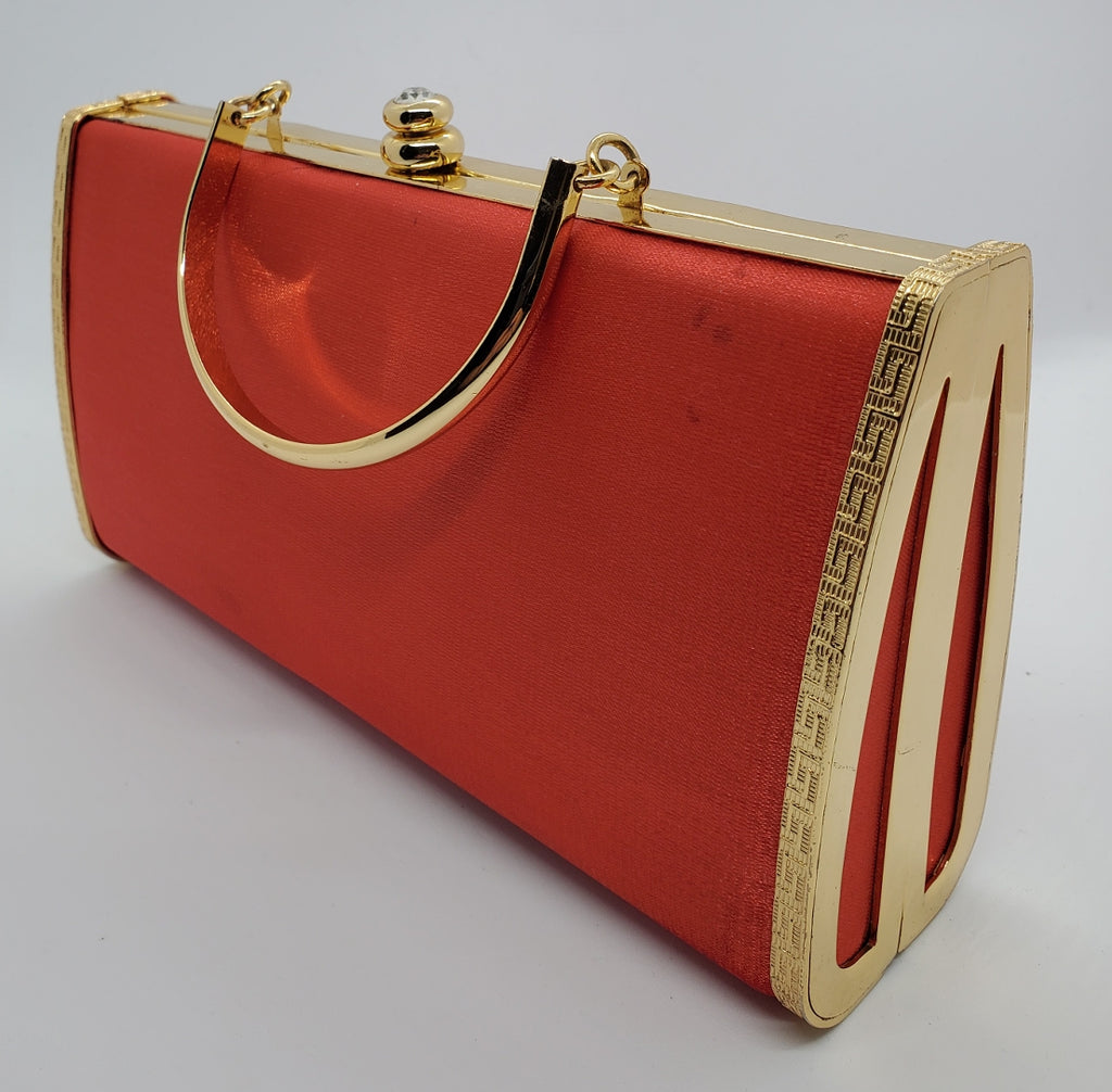 Side front view of Red and gold vintage hard shell bag