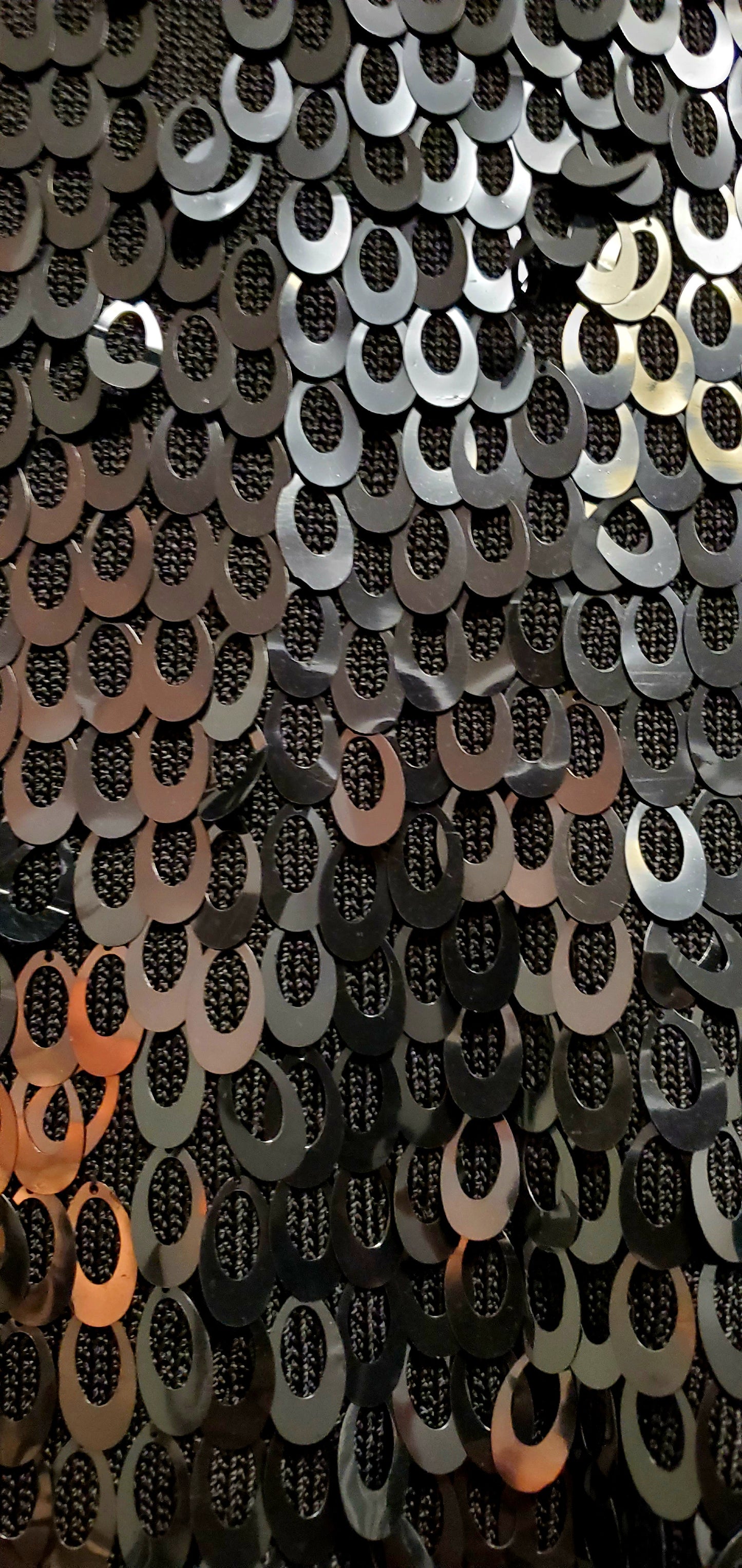 Front view of circular paillettes on knitted tank top