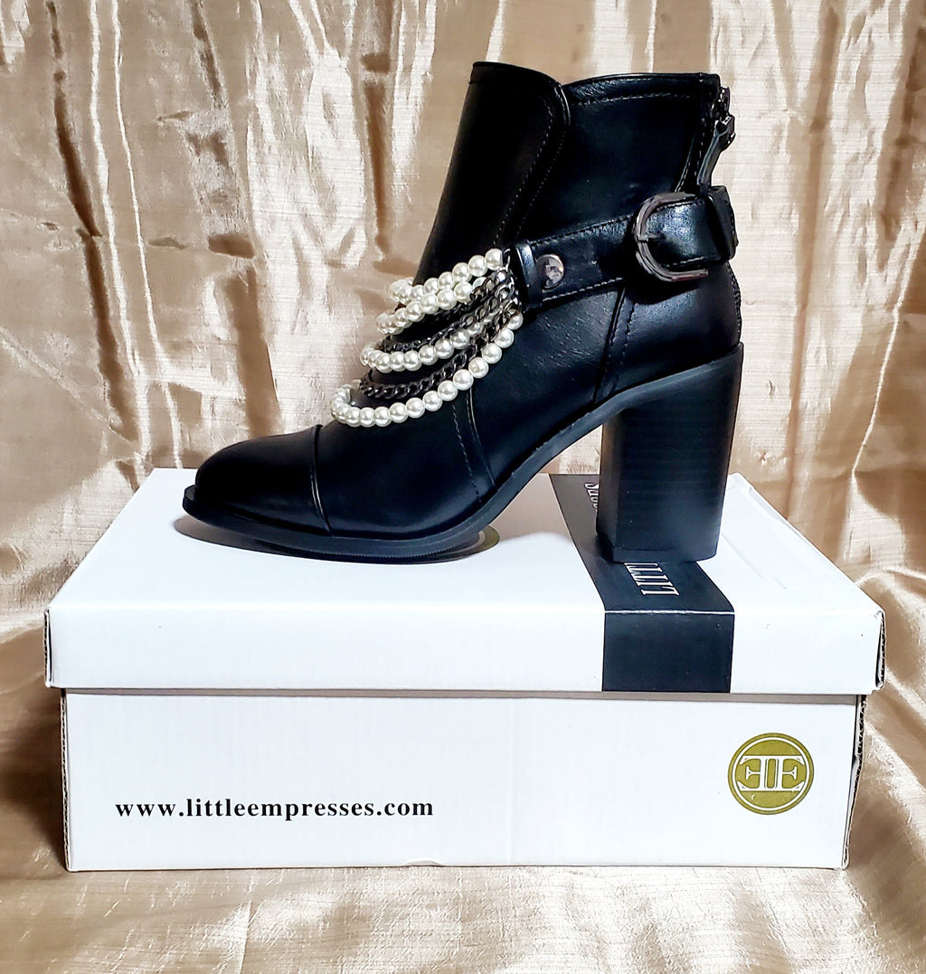 Side view of Black booties with pearl and chain details