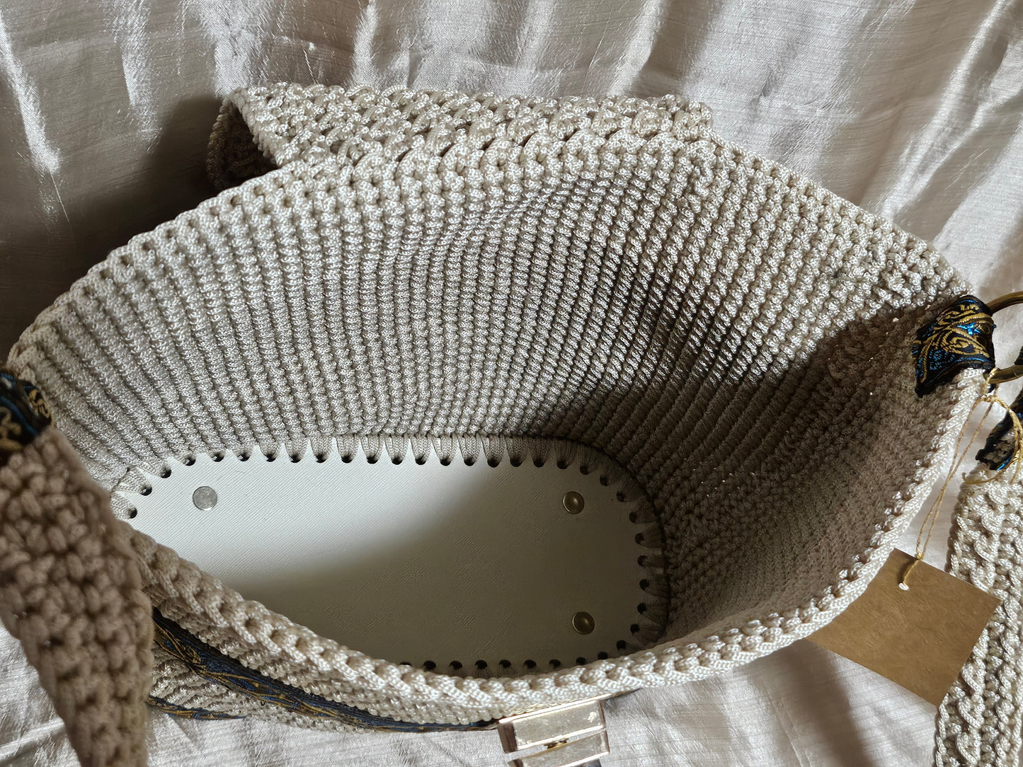Inside view of Cream coloured crochet handbag with Teal and Gold paisley trim