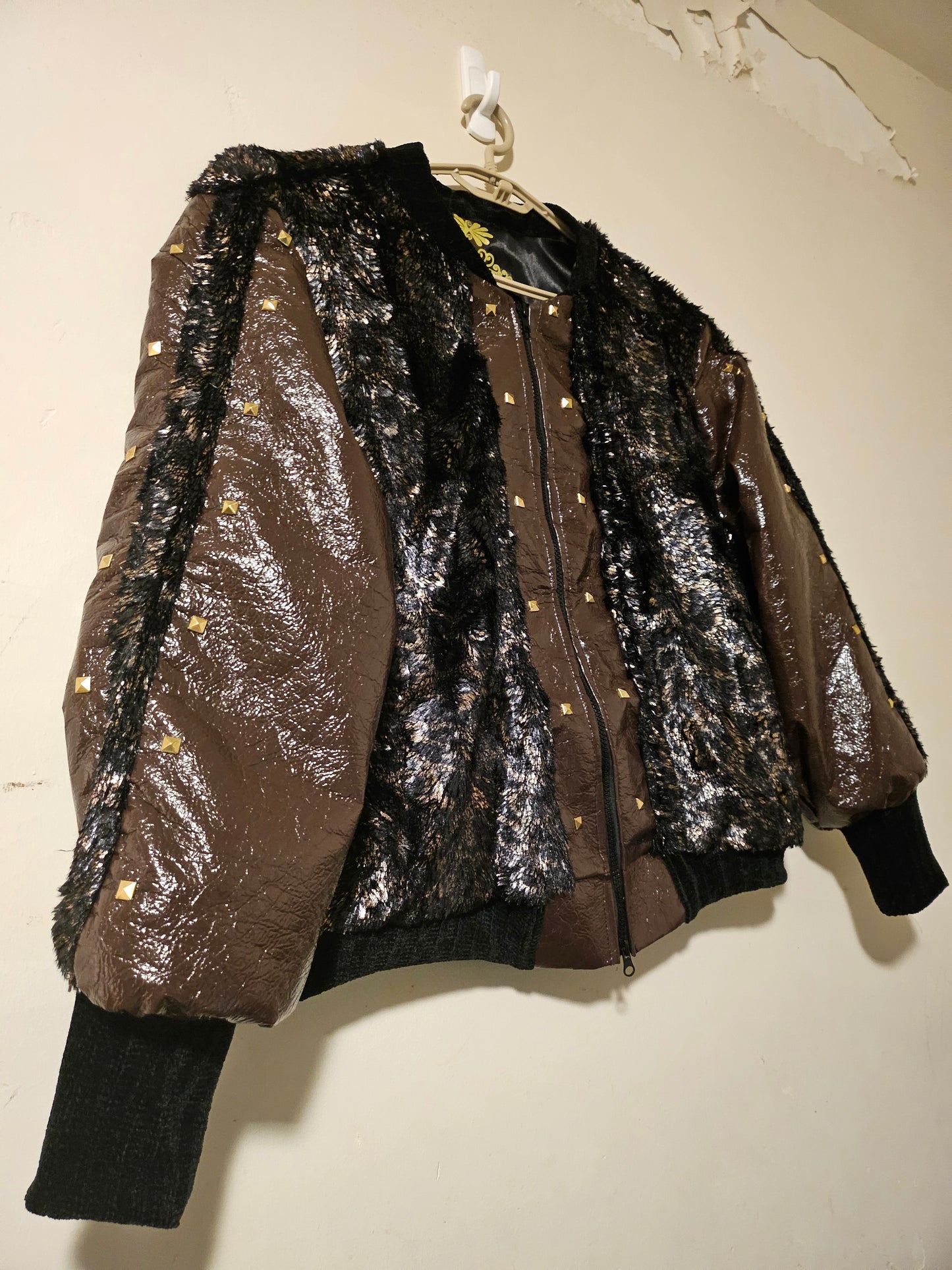 side view of Faux fur and patent leather bomber jacket with stud details