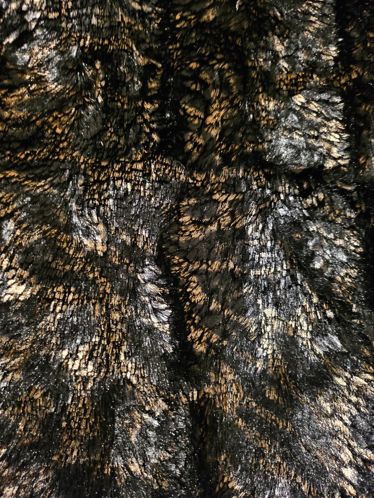 close up of faux fur of Faux fur and patent leather bomber jacket with stud details