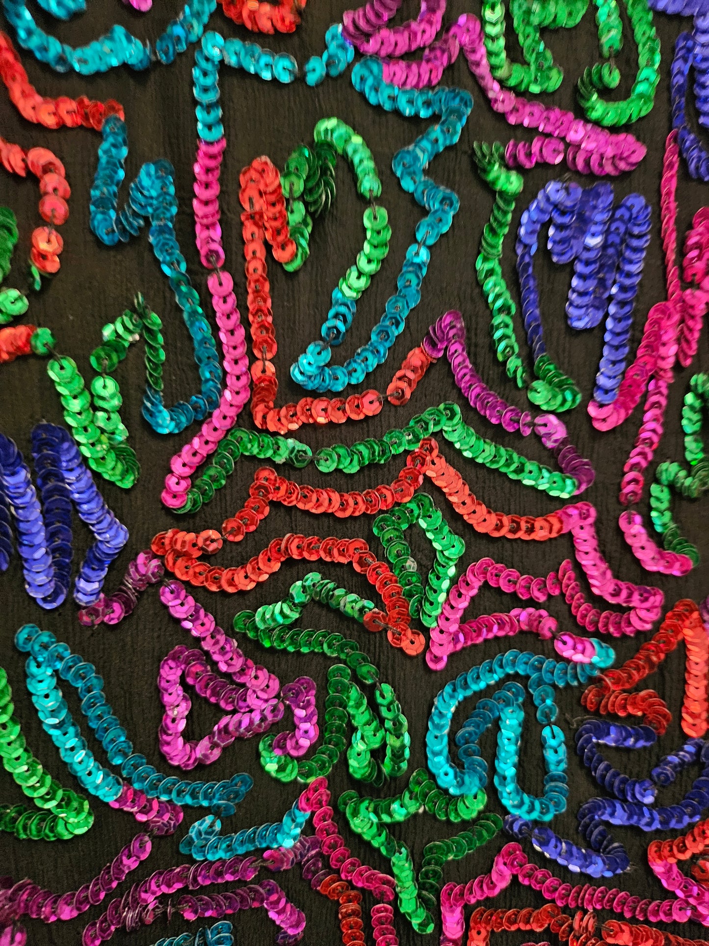 Close up view of sequins on Rainbow sequined jacket dress with fringe details