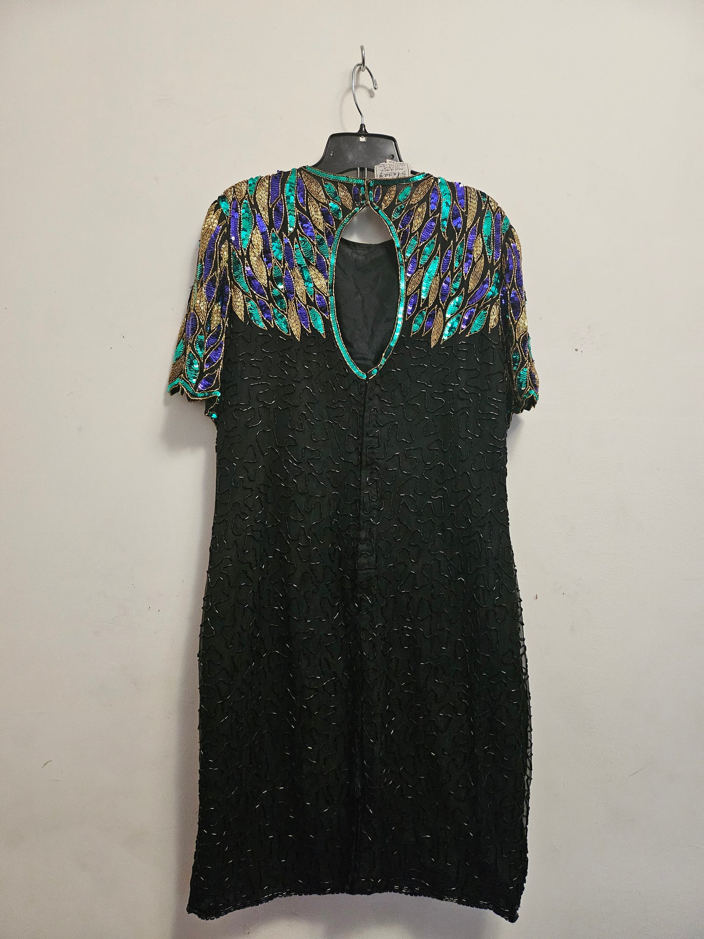 back view of 80s Peacock Beaded Cocktail Dress on hanger