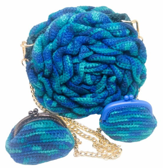 Front view of variegated blue and teal 3D Floral crochet handbag and gold chain strap with matching coin purse accessories.