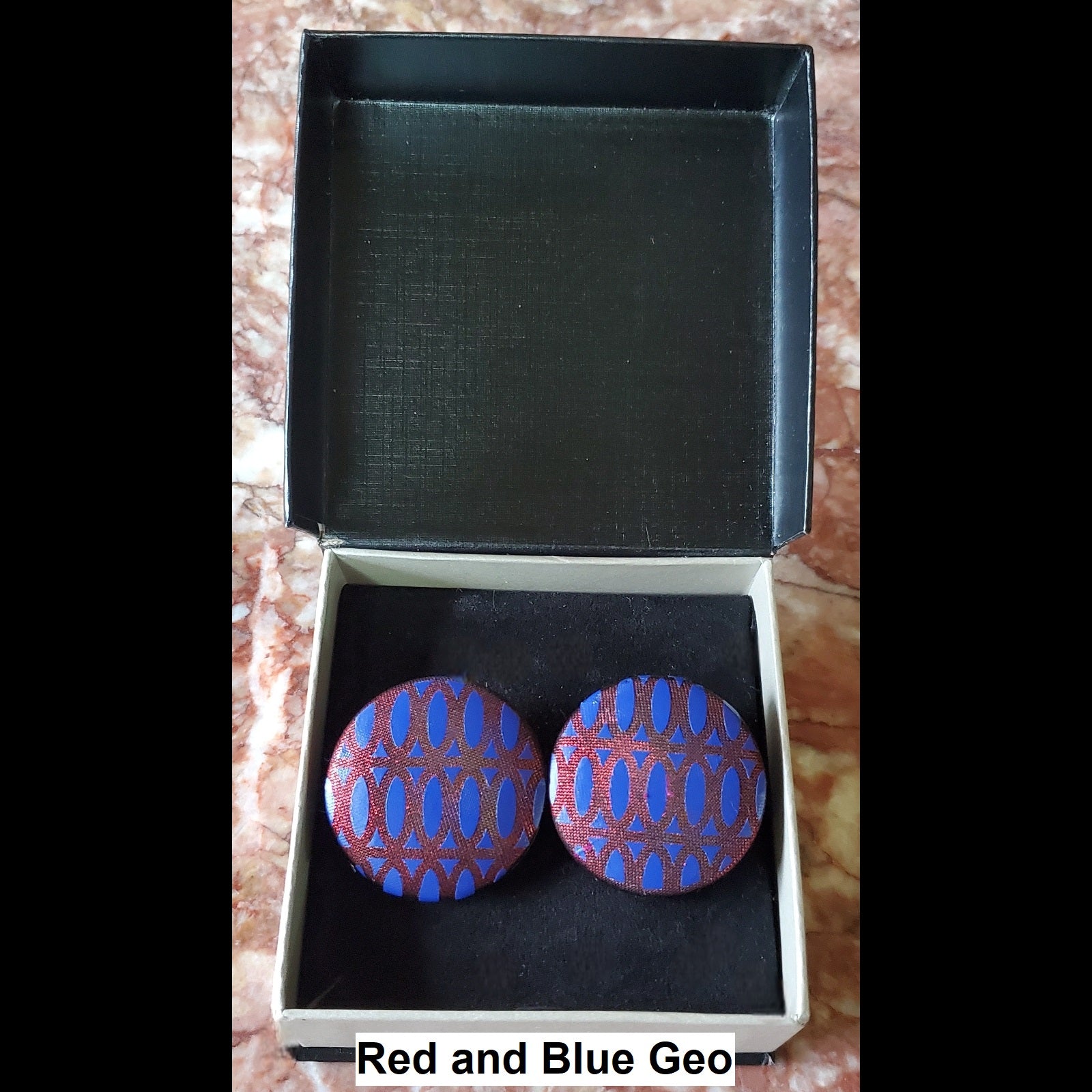Red and Blue Geo print button earrings in jewelry box