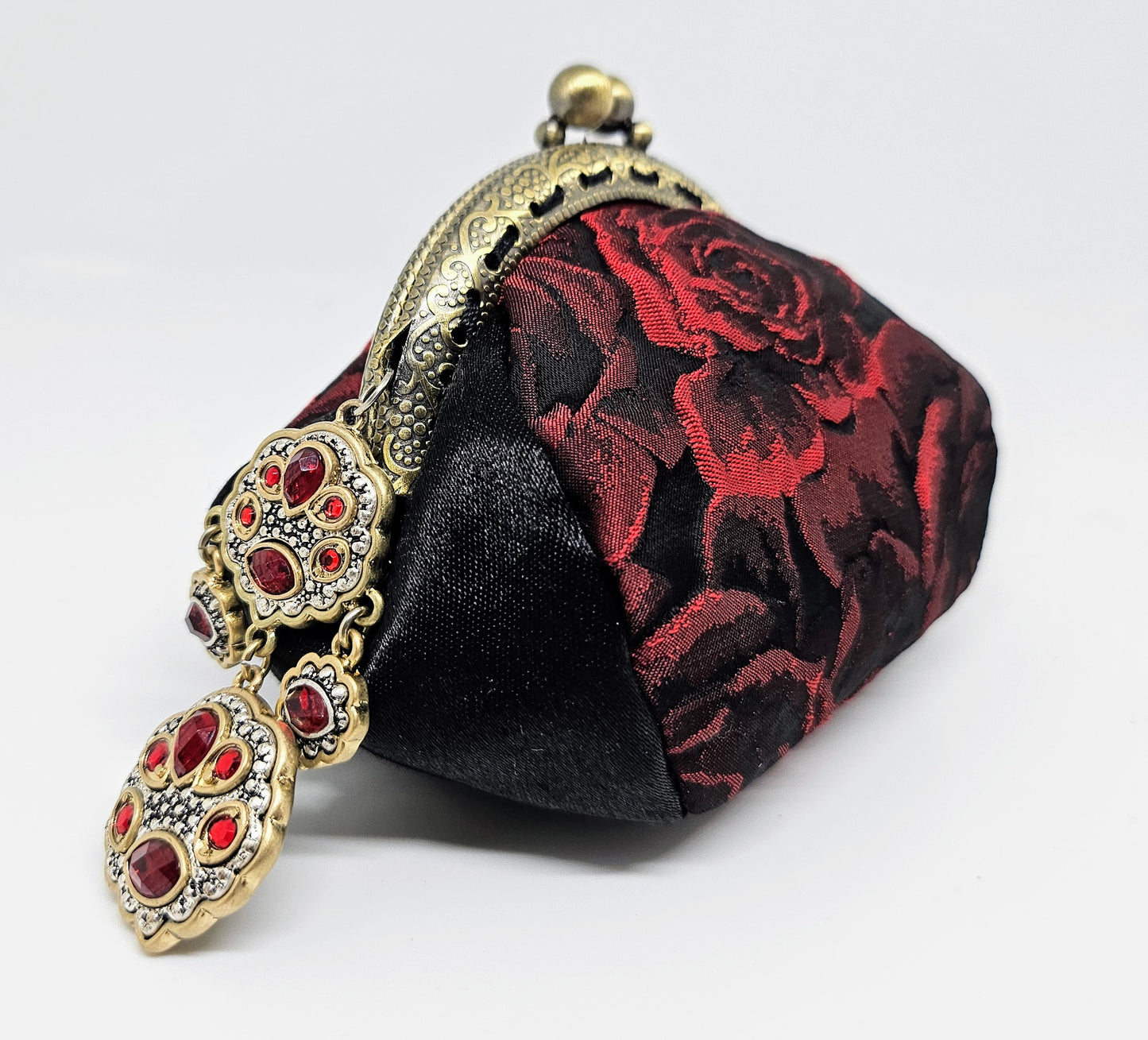 Left side view of 3D rose print kiss clasp coin purse with ornated jeweled charm