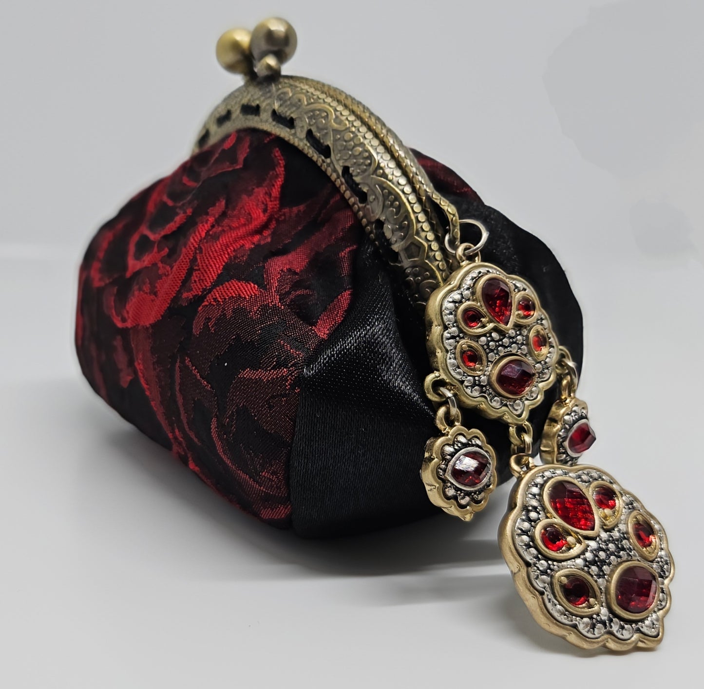 Right side view of 3D rose print kiss clasp coin purse with ornated jeweled charm