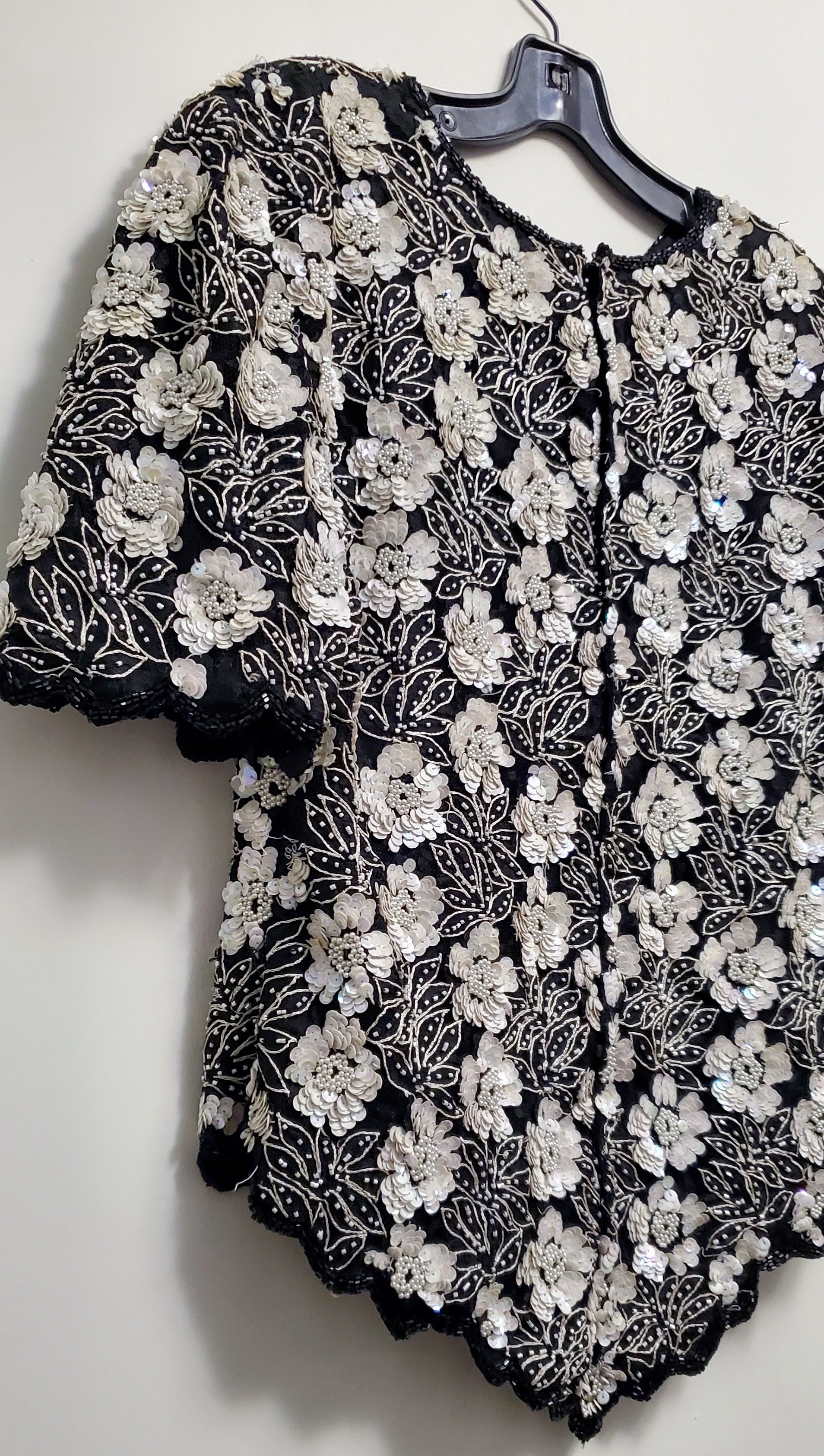 Side back view of Vintage 80s Black and White Beaded Floral Top