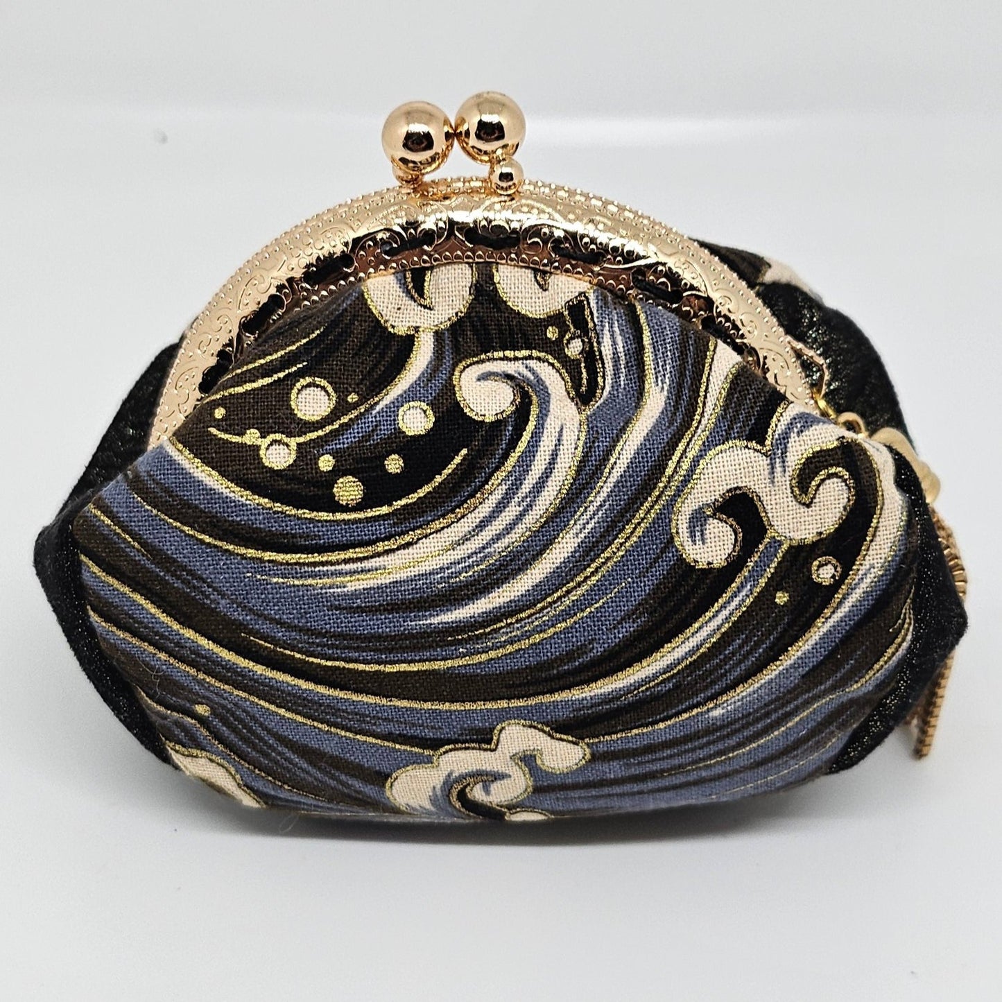 Front view of Wave print kiss clasp coin purse with gold tassel