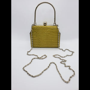 Front view of Lime green hard shell croc embossed purse with chain strap.