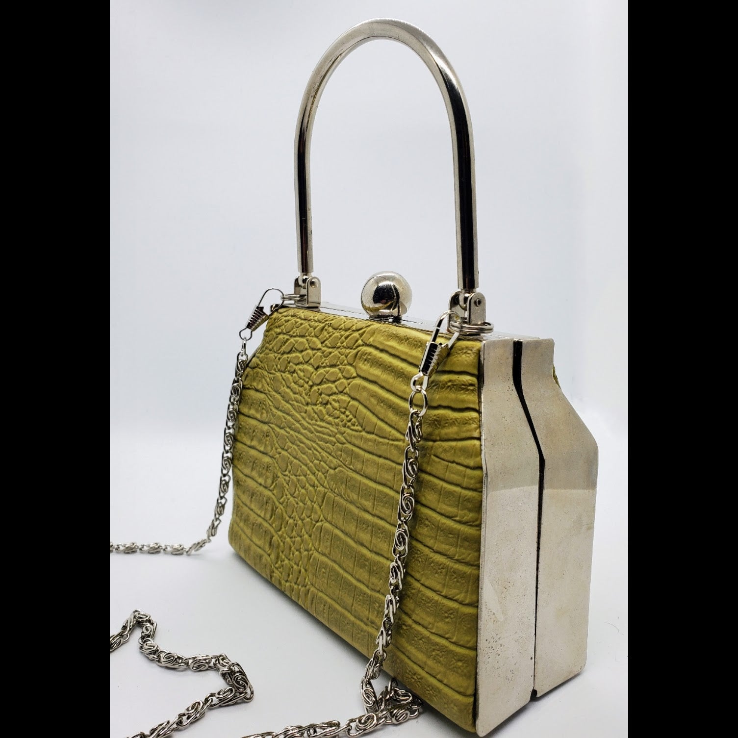 Side view of Lime green hard shell croc embossed purse