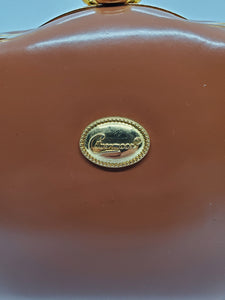 handbag tag view of tan and gold hard shell retro handbag