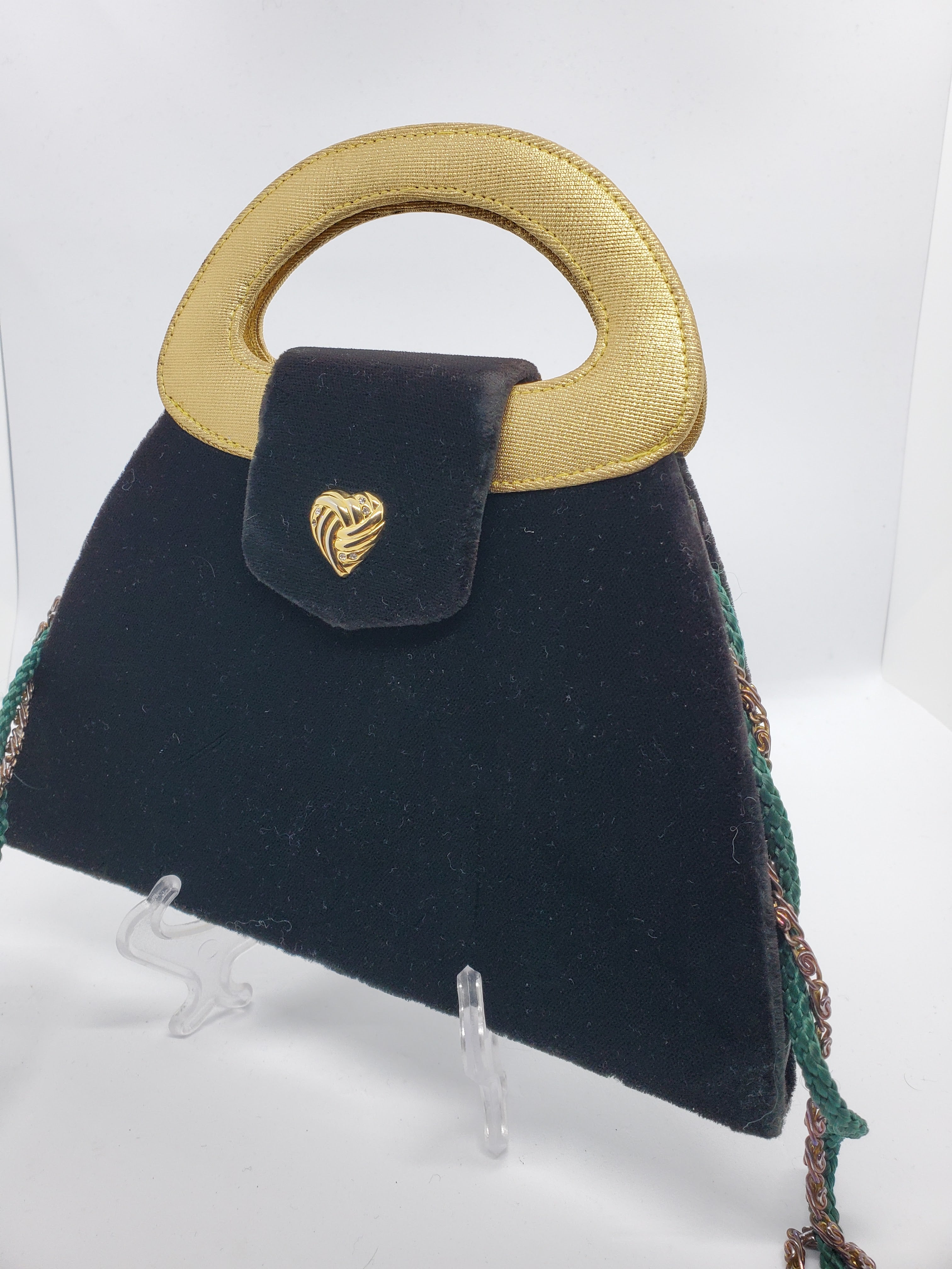 side view of green and gold velvet handbag with heart detail