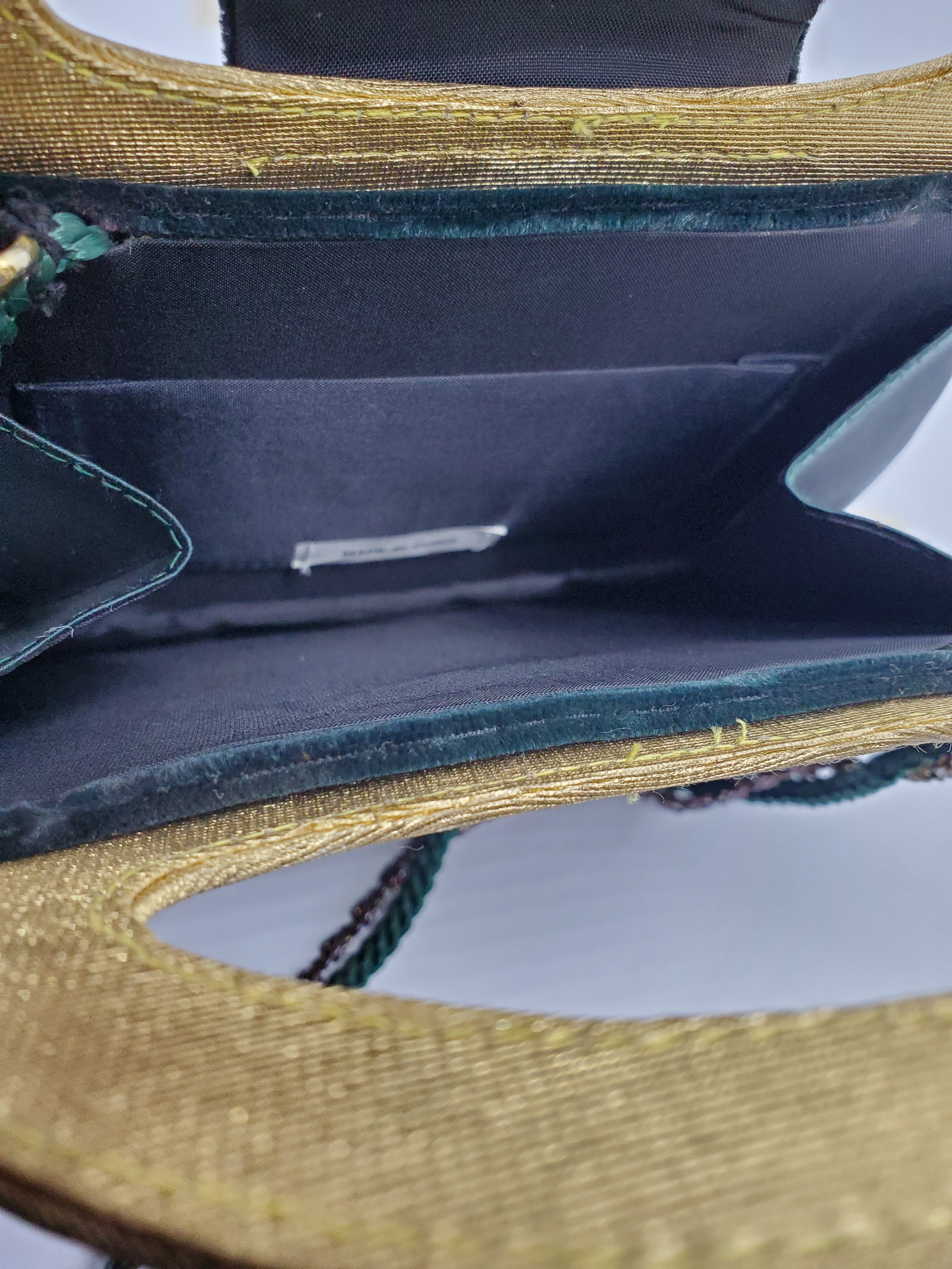 inner view of green and gold velvet handbag with heart detail
