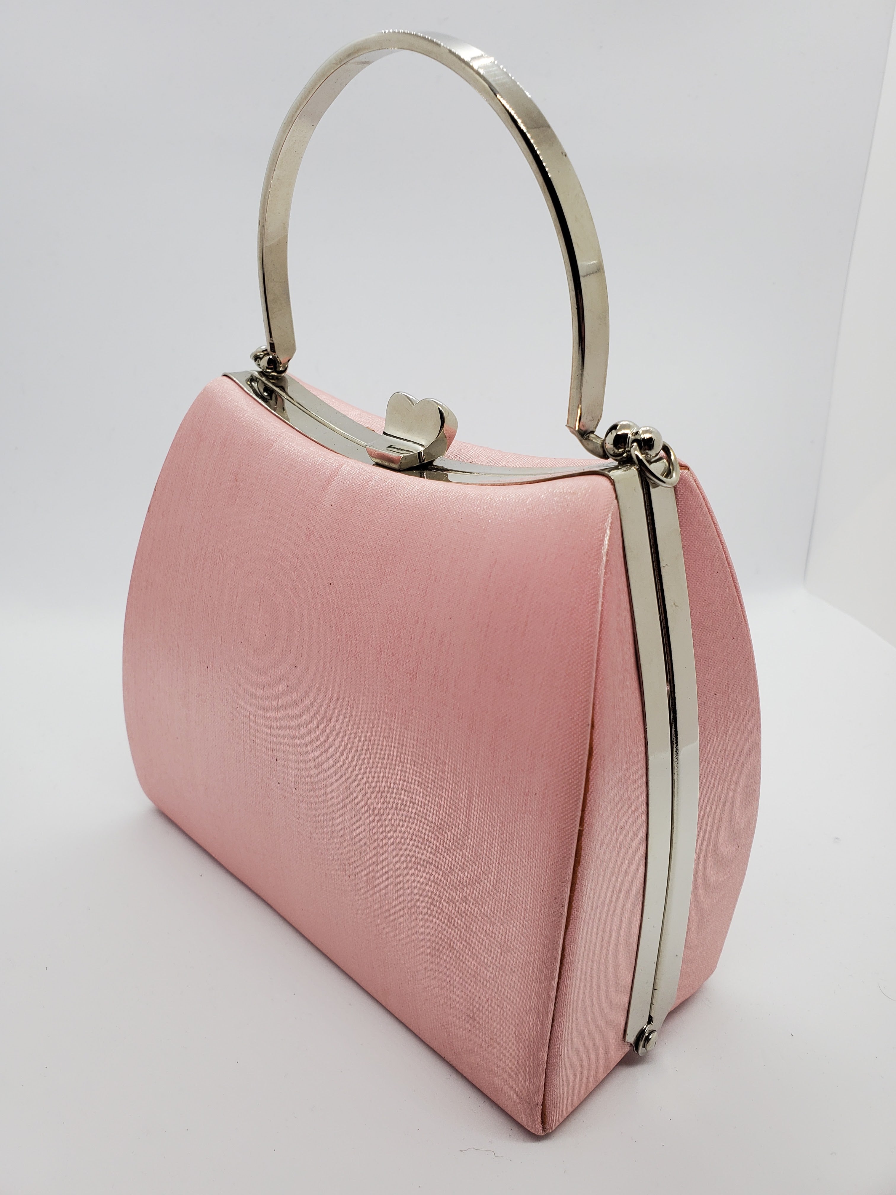 Side View of Light pink satin hard shell purse