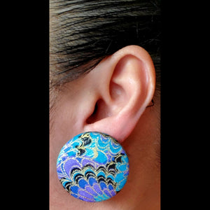 turquoise and purple swirl printed button earring worn on ear