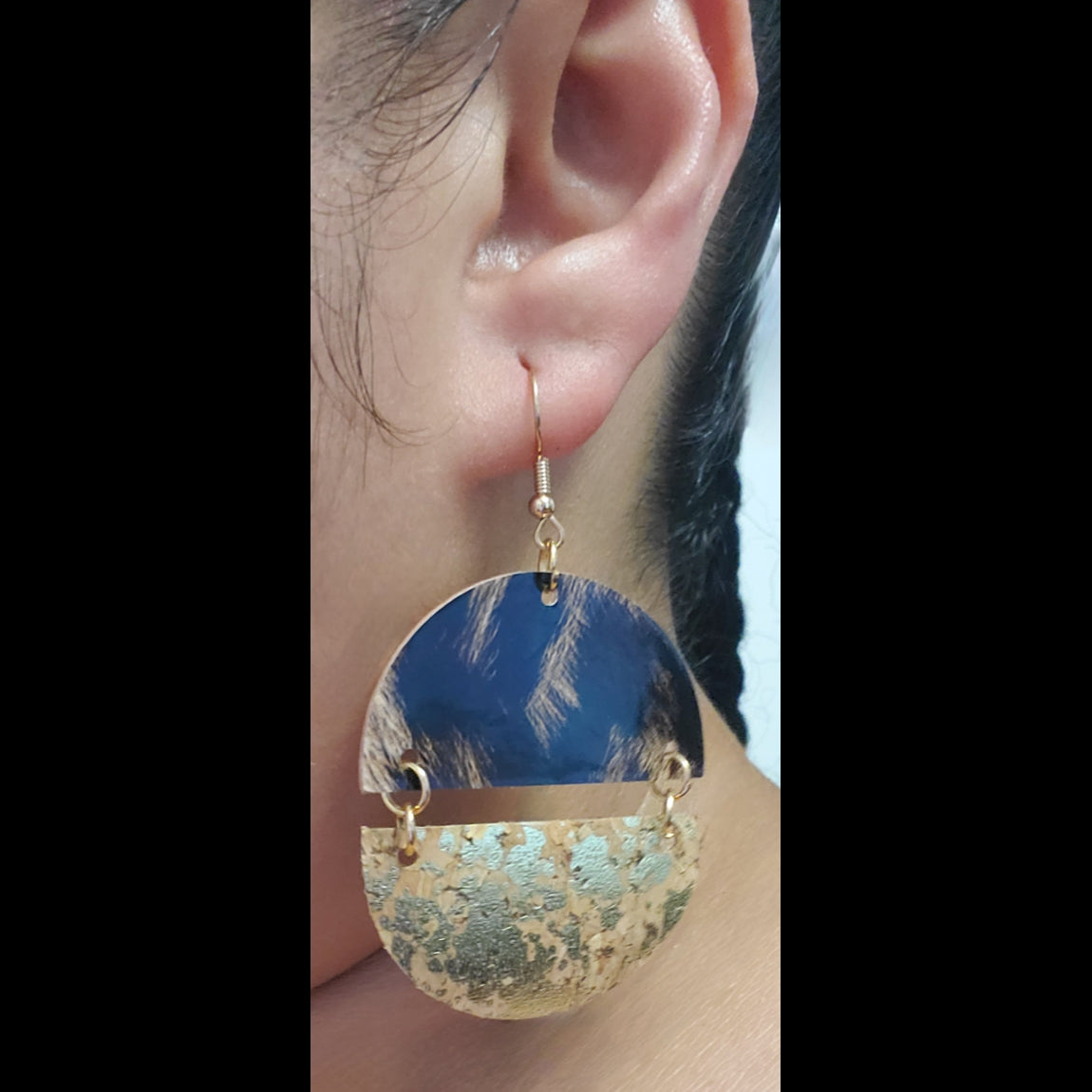Cork with gold accent and leopard print vinyl earrings on model