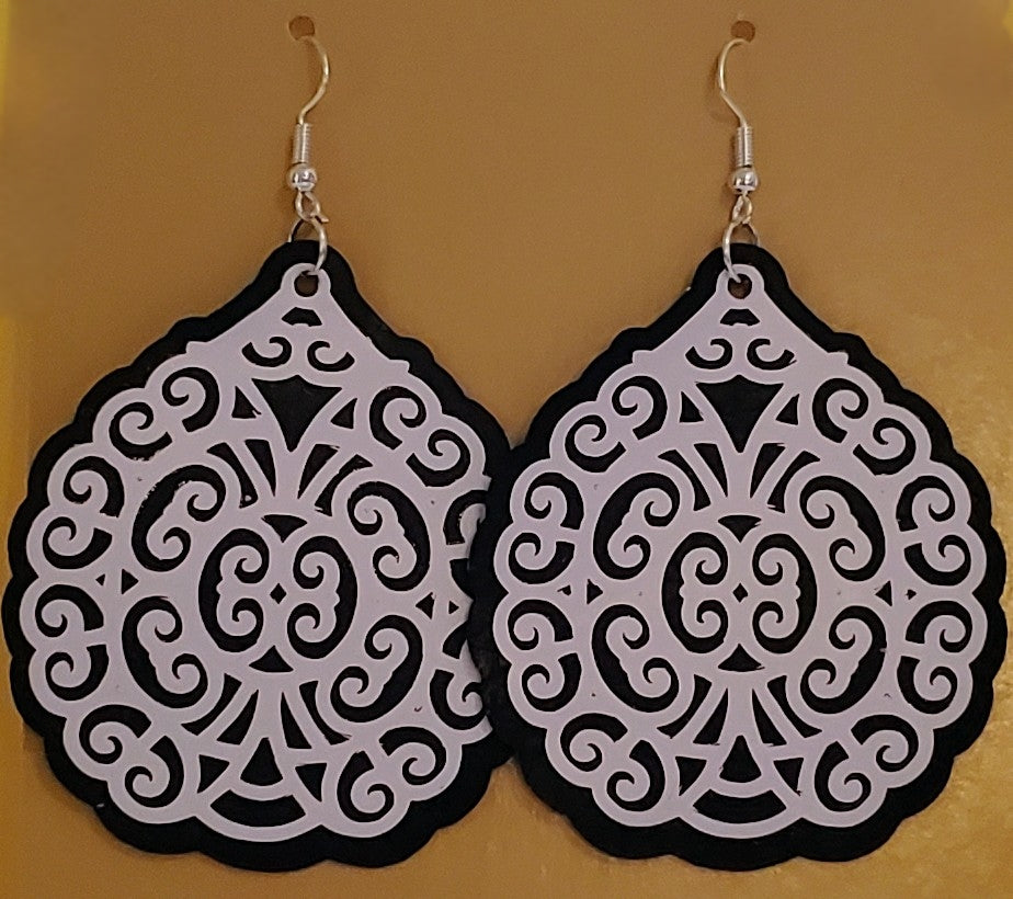 White on black filigree printed vinyl earrings.