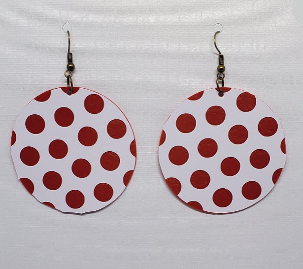 Red and white polka dot earrings on stand