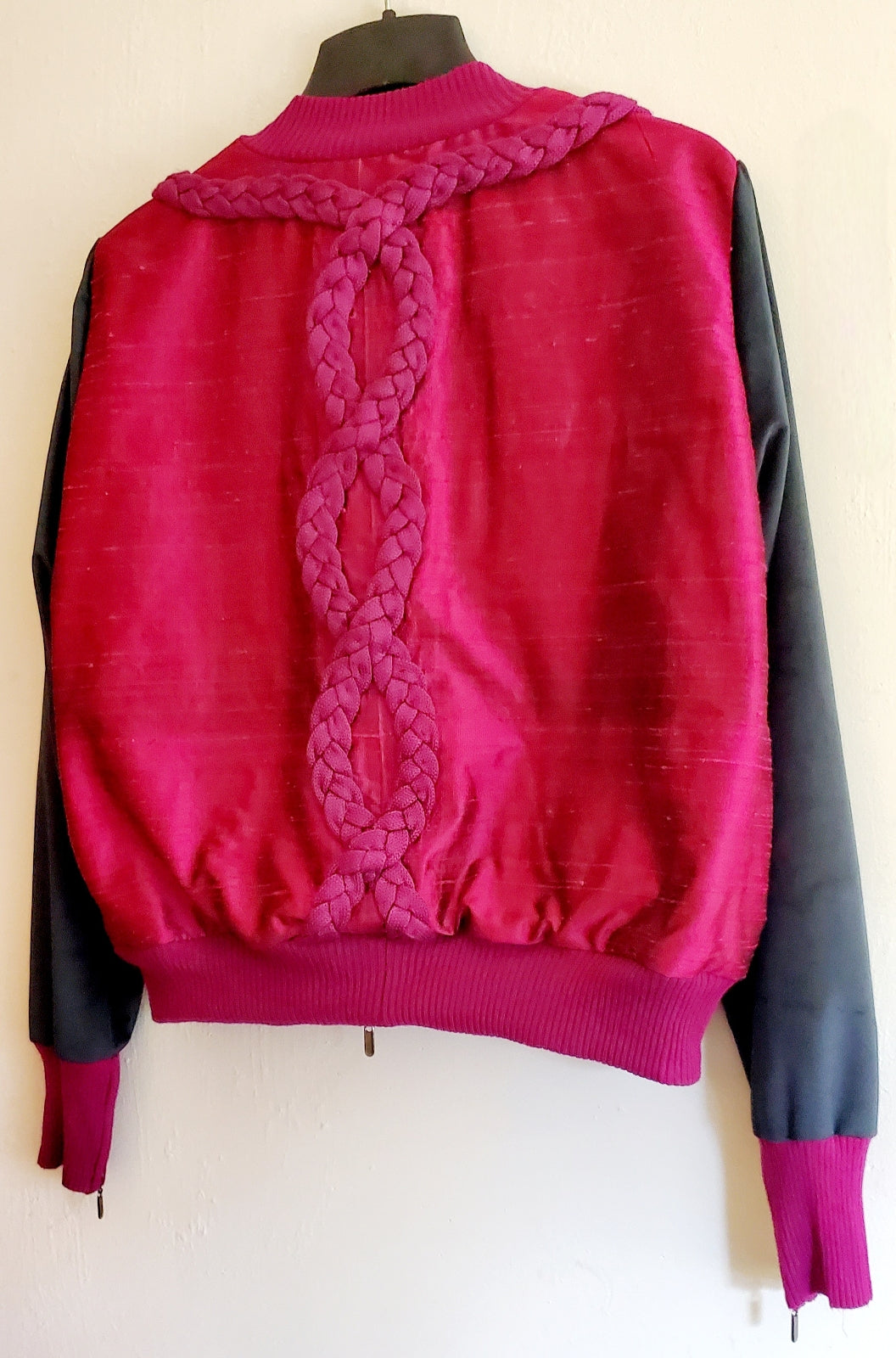 close up back view of Cable knit and raw silk jacket with velveteen sleeves