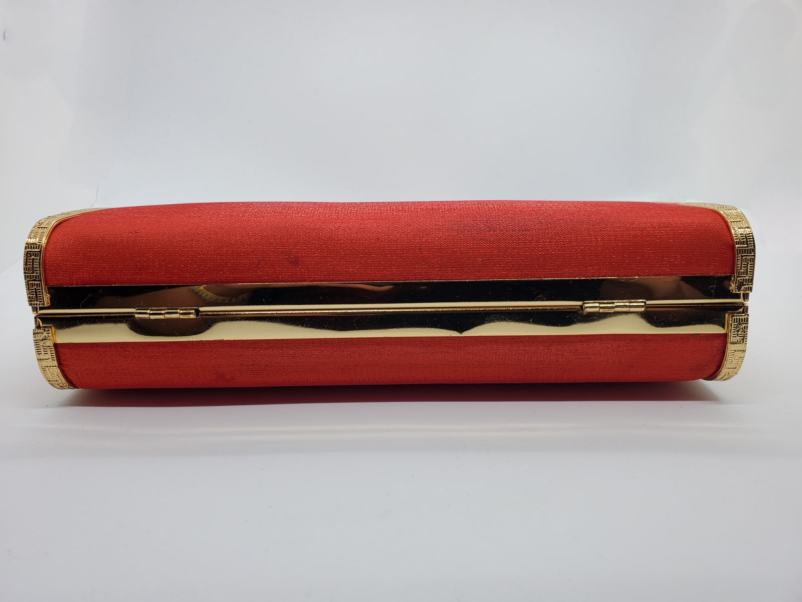 Bottom view of Red and gold vintage hard shell bag