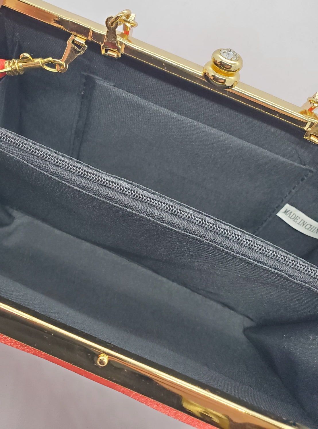 Lining view of Red and gold vintage hard shell bag