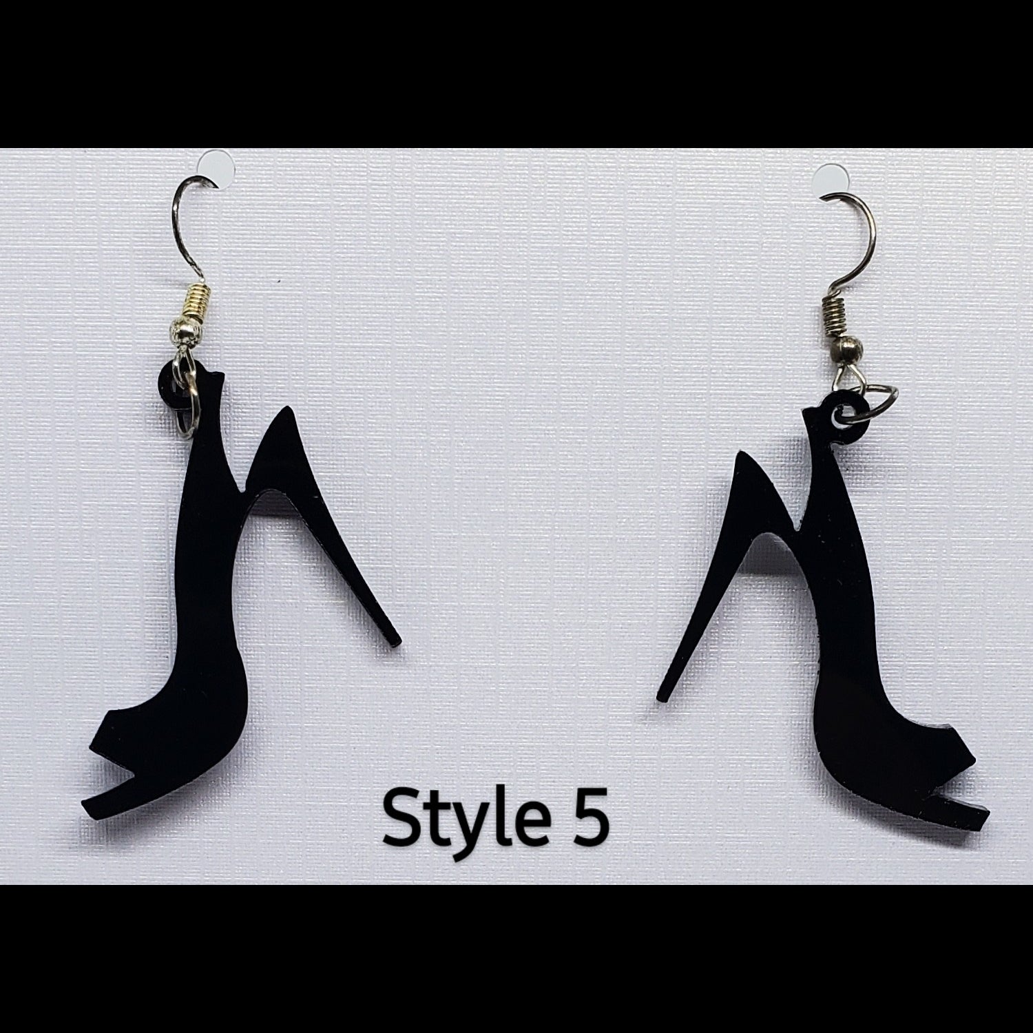 Black open toe heel acrylic shoe earrings on stand