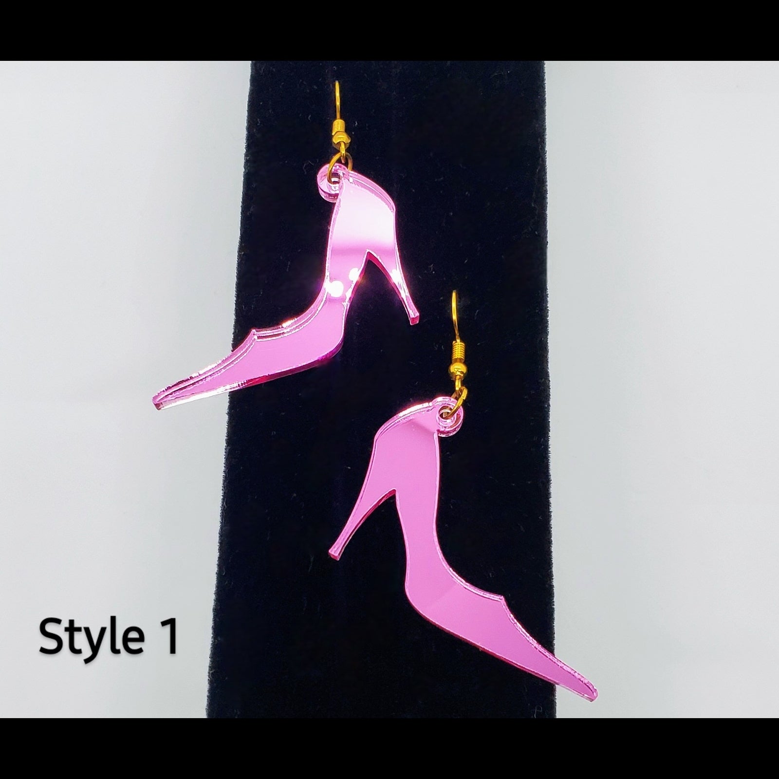 Metallic pink pumps acrylic shoe earrings on stand