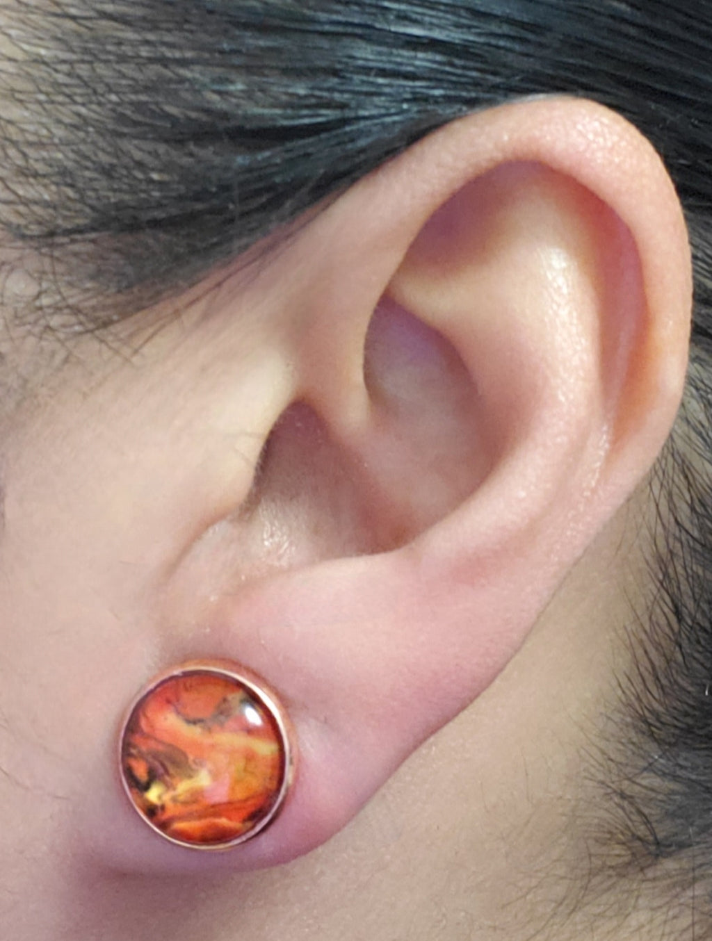 Red marble cabochon stud earrings on model
