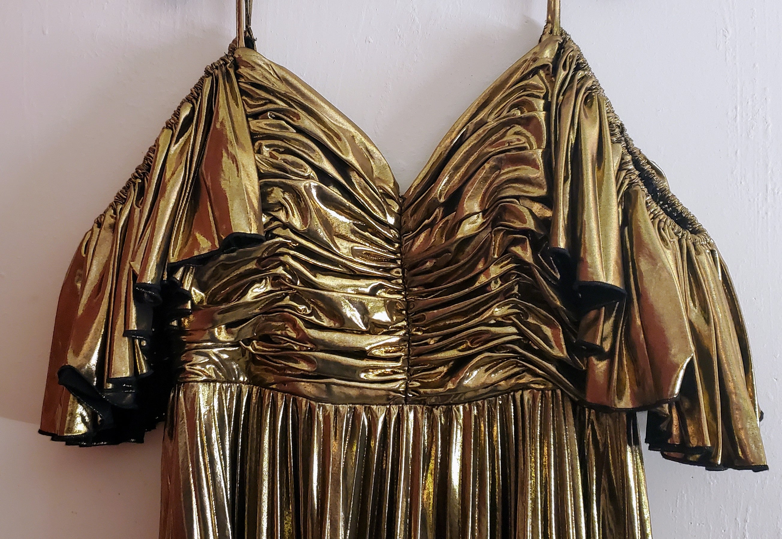 Front top view of a gold ruffled dress