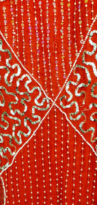 close up view of sequins and fabric of vintage red and silver sequin dress