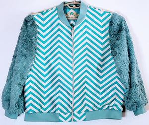 Front view ofTurquoise chevron print bomber jacket with sequined fur sleeves 