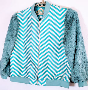 Close up Front view of Turquoise chevron print bomber jacket with sequined fur sleeves