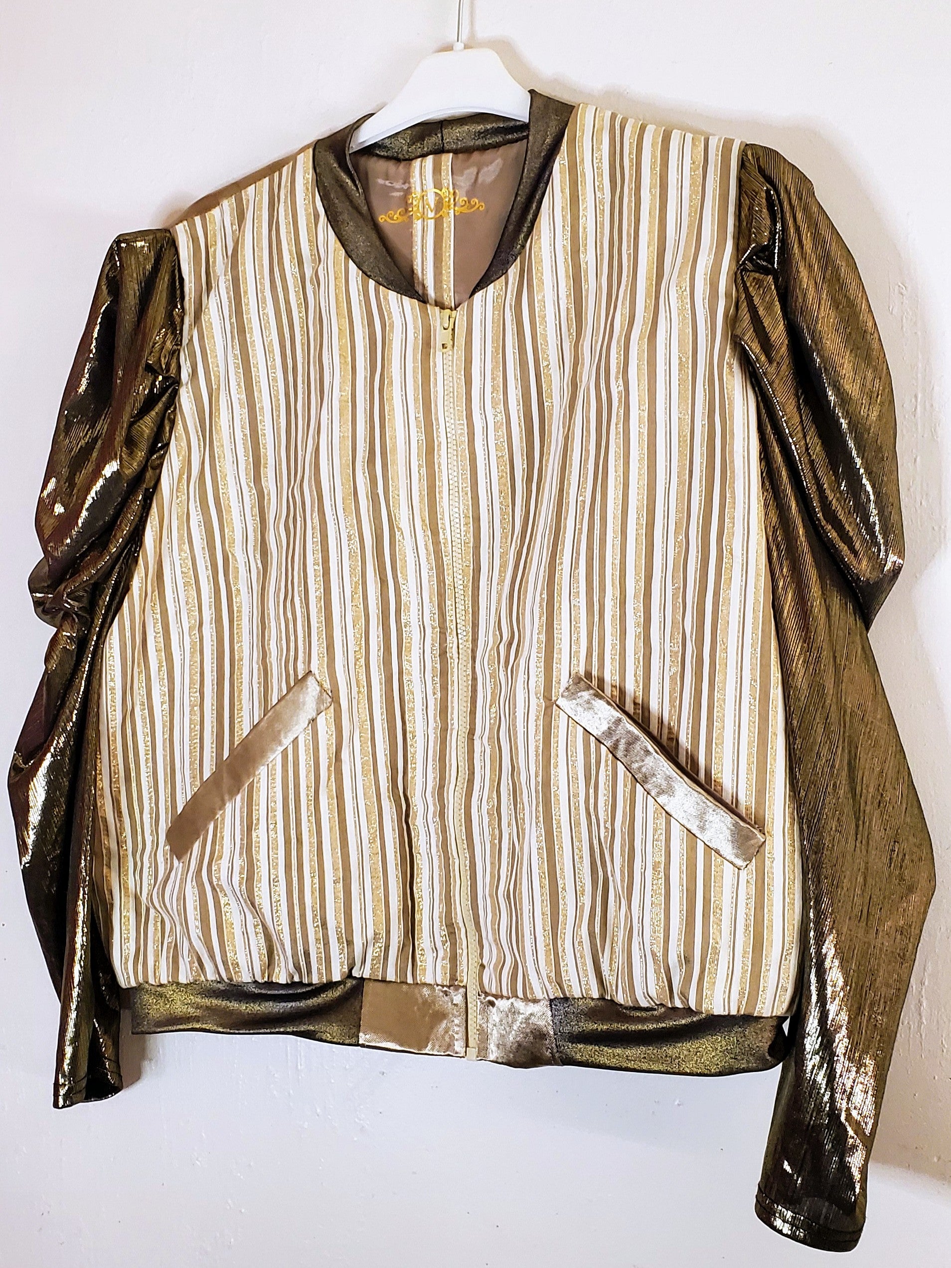 Close up Front view of Gold and ivory striped bomber jacket with gigot sleeves