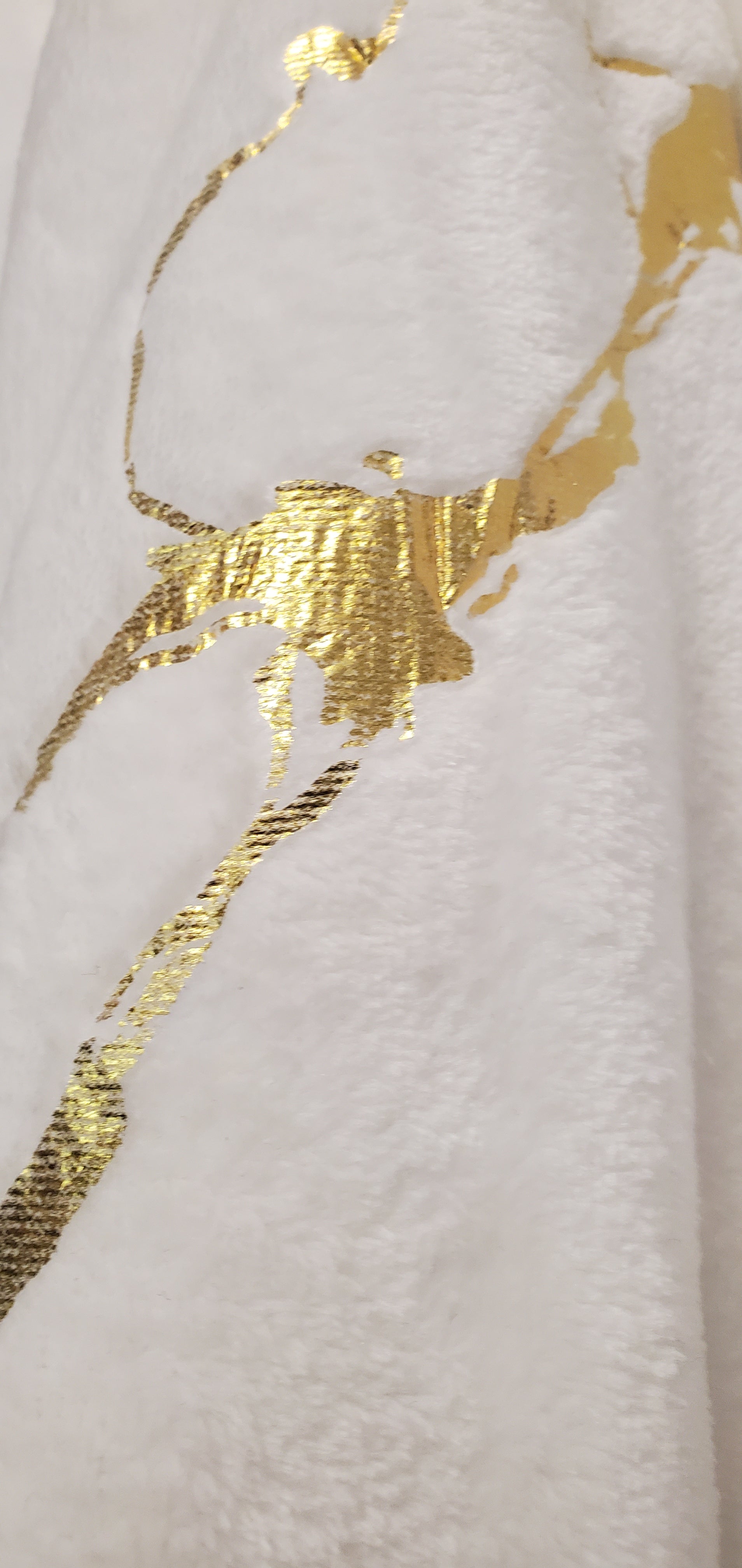 Close up view gold marble print sleeves