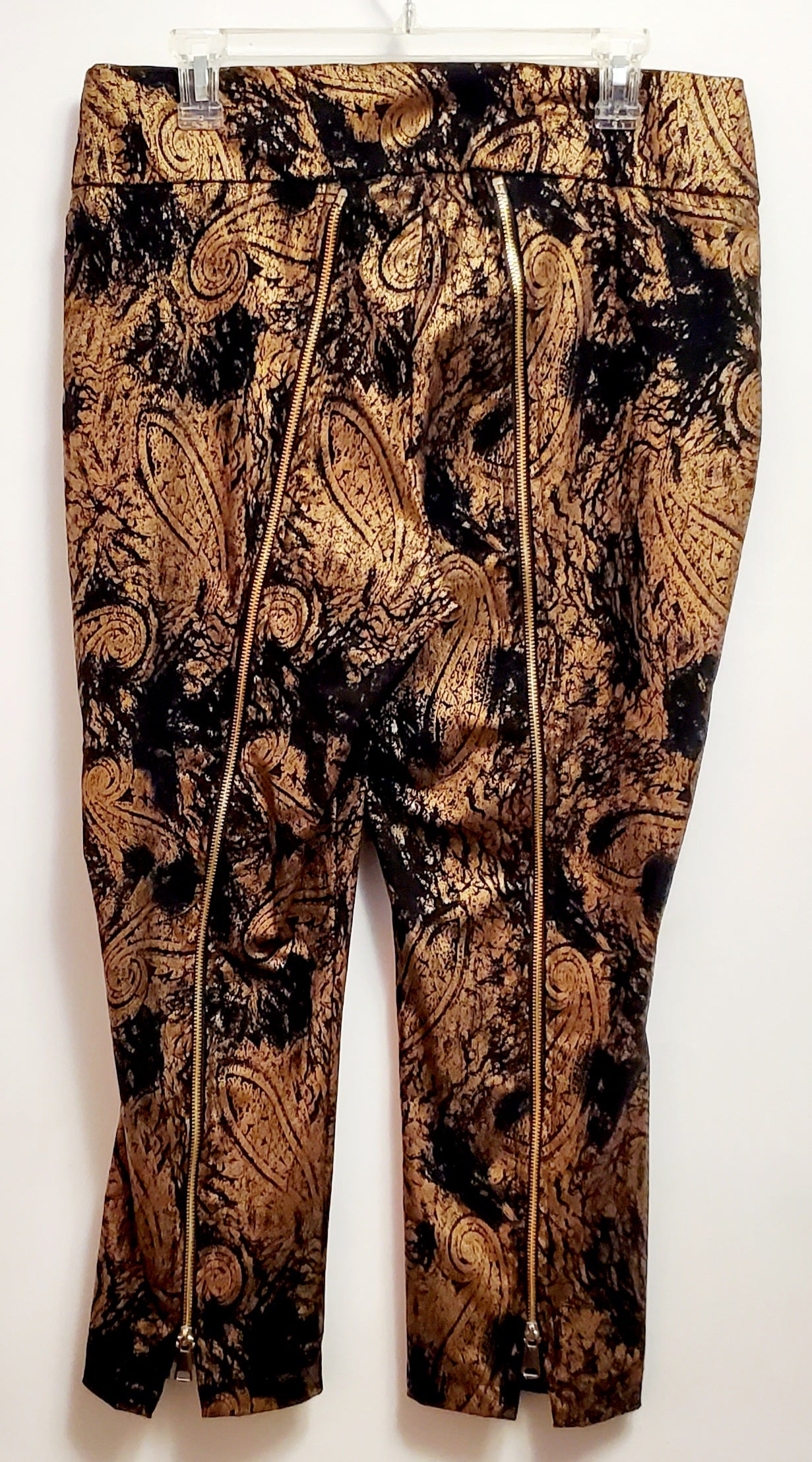 Back view of cropped pants of 2 piece black and gold paisley suit with lace wing epaulettes
