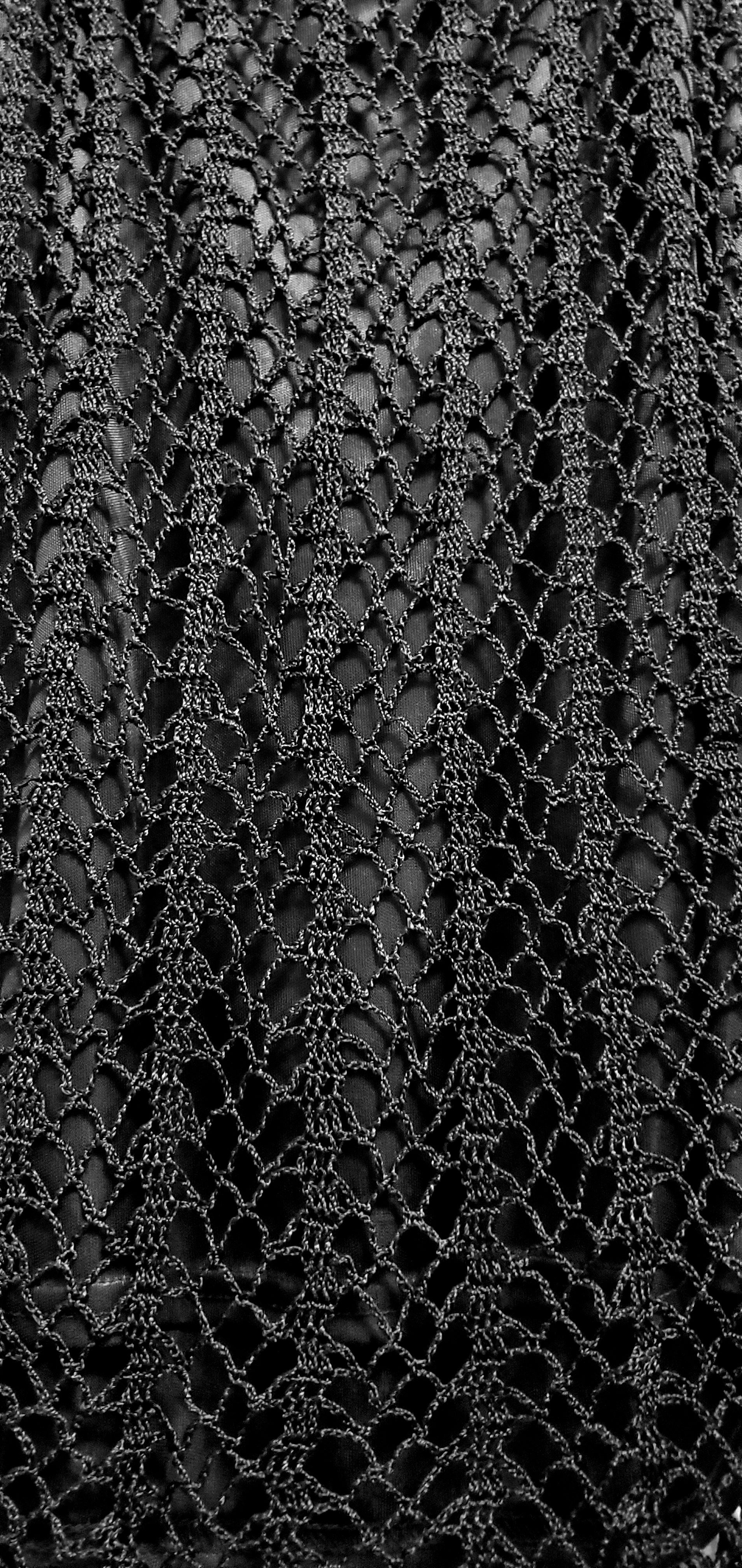 Close up of crochet stitches at back of 90s black crochet beaded top