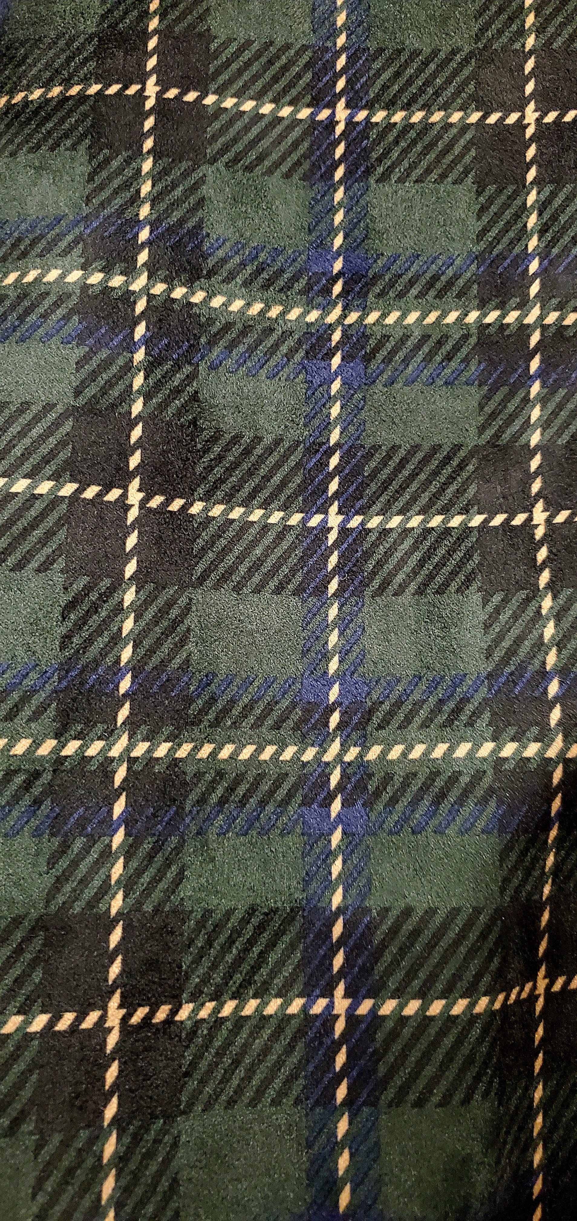 close up view of plaid fabric of Forest green plaid bomber jacket with split sleeves and laced shoulder details.