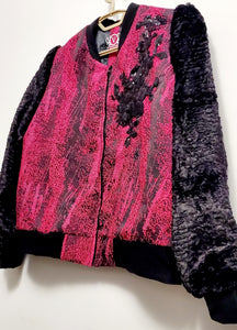 Close up Front view of Fuchsia and black bomber jacket with faux fur sleeves and sequin applique details