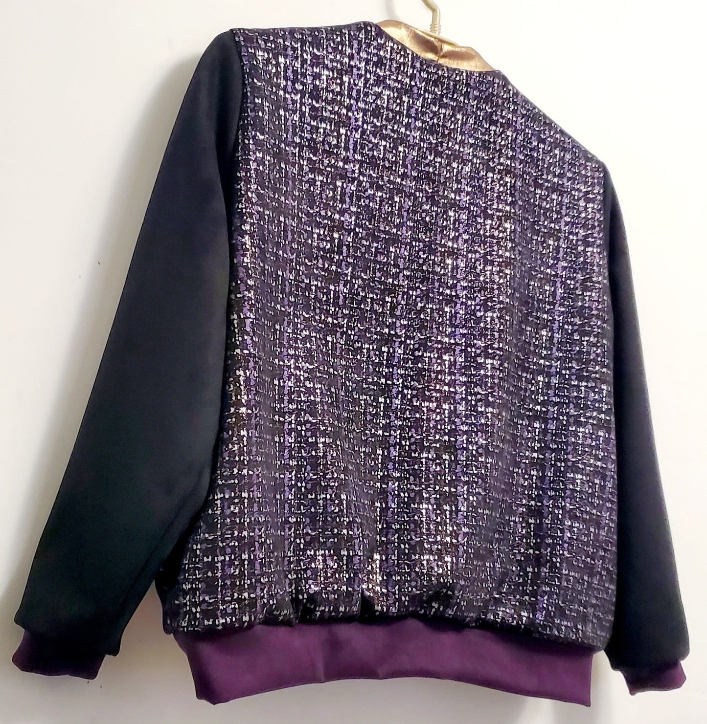 Close up of back of Purple, silver, and copper tweed printed bomber jacket