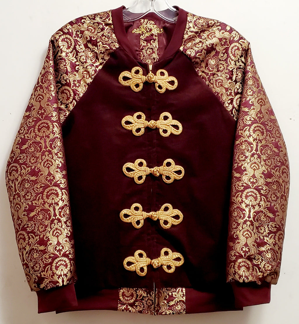 front view of Burgundy corduroy bomber jacket with metallic gold sleeve and knot closures