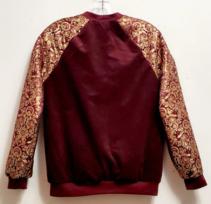 back view of Burgundy corduroy bomber jacket with metallic gold sleeve and knot closures