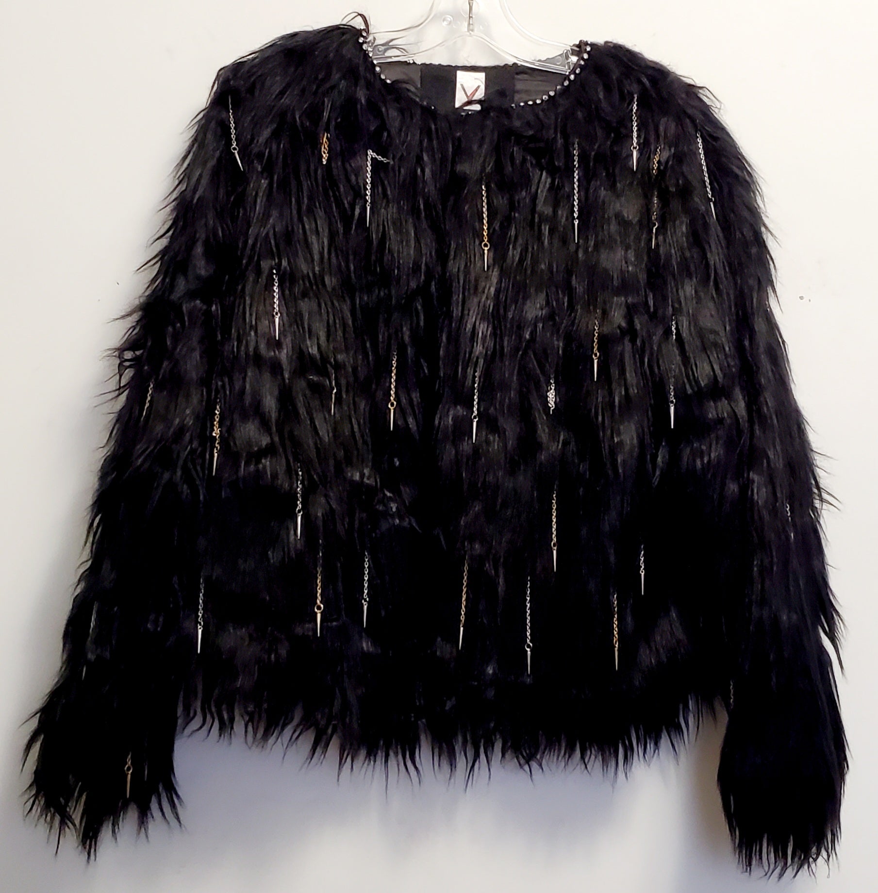 front view of faux fur black coat with chain and spike details 