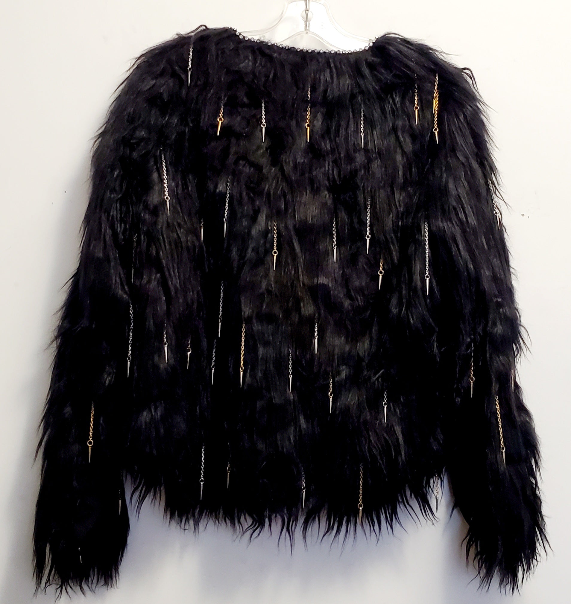 back view of faux fur black coat with chain and spike details 