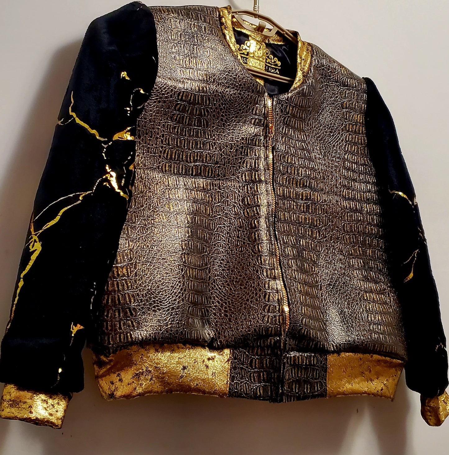 Close up view of front view of Faux alligator and marbled fur bomber jacket